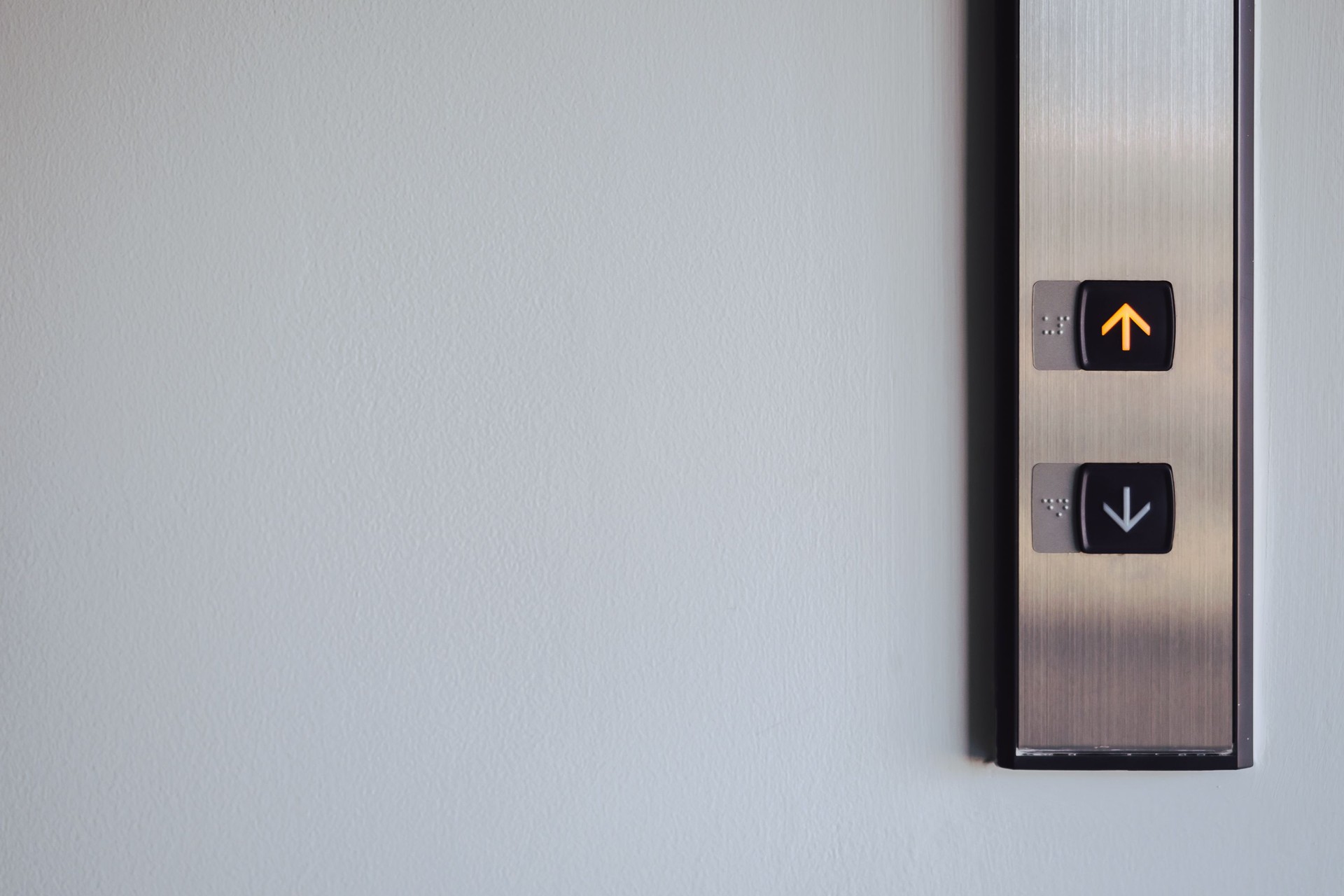 Up and down button in front of the Elevator for direction, up red light with copy space