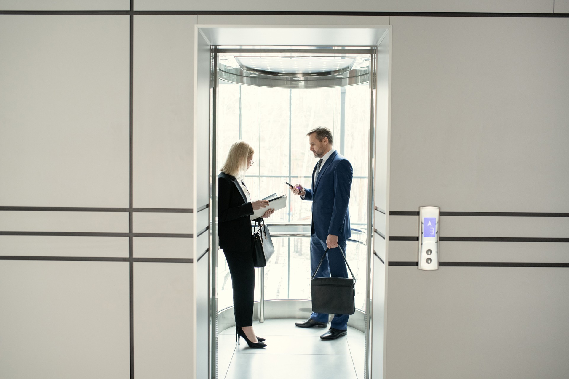 Business people standing in elevator